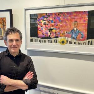 Man standing in front of framed prints
