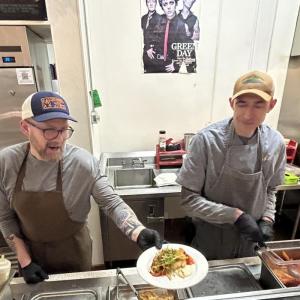 Ryan Tinker and Crispin Goodnow, in the Camden Hills Regional High School kitchen Jan. 28, serving up Graffam Seafood's Maine Coiast Founder Fishcake with a topping of Wakame Slaw. (Photo by Lynda Clancy)