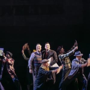 Group dance scene with the two actors in the middle