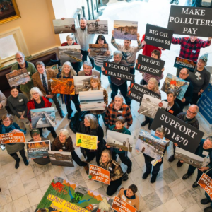 a crowd holding signs in support of L.D. 1870