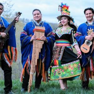 Three men, one woman musician dressed in traditional costumes