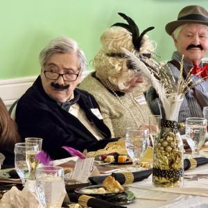 Two men, one woman in 1920s apparel