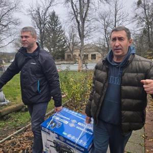 Volunteers deliver a generator in Kyiv