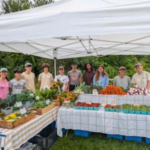 crew posing behind vendor display