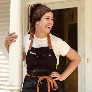 Woman leaning against post