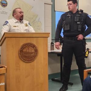 Chief behind podium recipient listens to the recognition