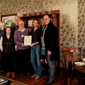 group photo next to pies on table