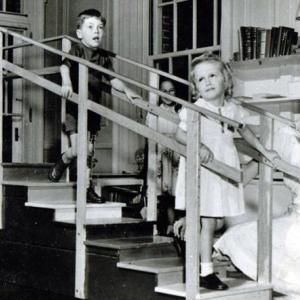Children on stairs with nurse