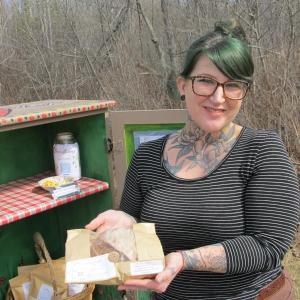 Whitney Brown by her Mossflower Cottage stand in Belmont. Photo by Kay Stephens