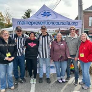 group photo including two men in referee shirts