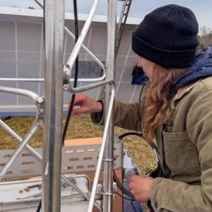 Female looks at section of weather tower
