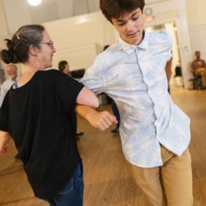female and male turn during a dance