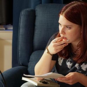 female sitting in chair