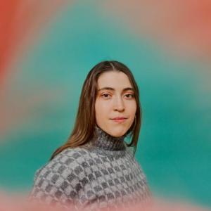 woman in portrait framed by pink cloud