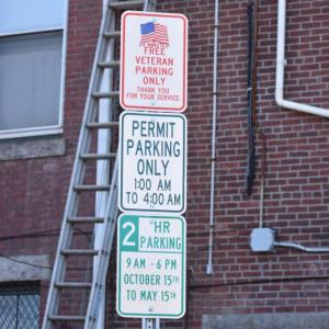 three signs on a vertical pole