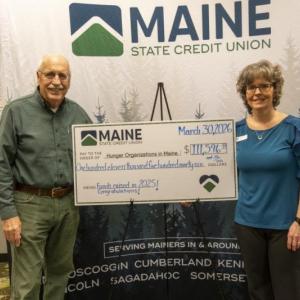 Two adults with oversized check