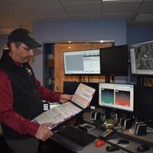 File Photo Knox Regional Communications Center director Robert Coombs shows an algorithm of emergency medical cards that lead dispatchers to certain medical situations based on responses by the 911 caller. (Photo by Sarah Thompson)