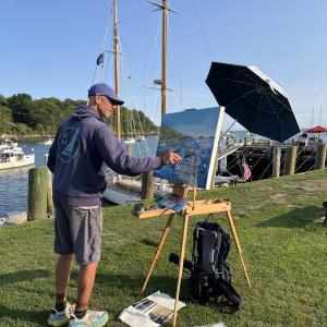 man painting at easel