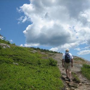hiker climbing toward peak