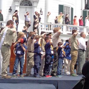 multi generations salute the flag