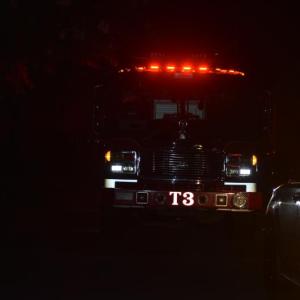 front of fire truck, rear of chief's vehicle