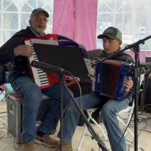 Eric Tolman and his grandson, Ben Tolman, play the accordion in honor of David Dickey (Photo courtesy Monica Tolman)