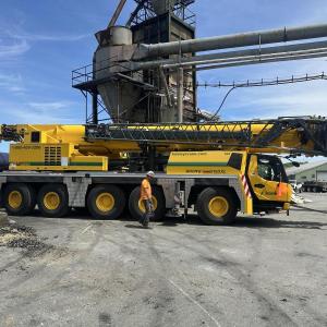 yellow crane truck at lumber yard