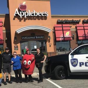 mascots, police cruiser outside restaurant