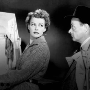 woman shows man a painting