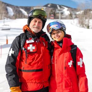 Man, teen girl ski patrollers