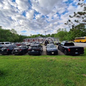 Cars begin to fill the lot at Edna Drinkwater School in Northport. (photo by Erica Thoms)