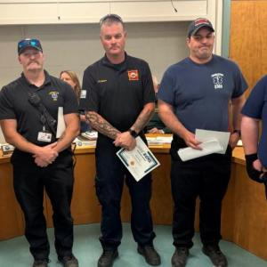 5 males pose with certificates of acknowledgement