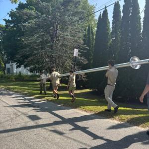 carrying flag pole, rear view