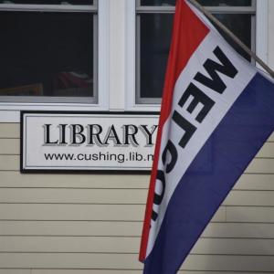 library sign and welcome flag