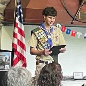 Scout looks at award during ceremony