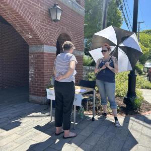 Outside the Rockport Public Library where tables are set up for advocacy efforts. 