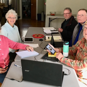 five adults sit at a table