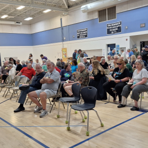 People filter into the auditorium, slowly filling seats. (photo by Erica Thoms)