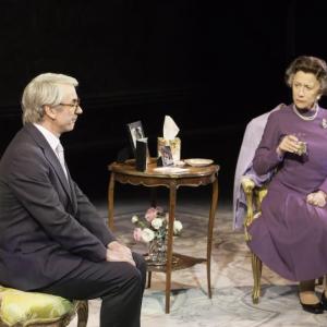 man and woman sit in conference