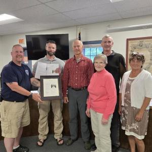presenting framed acknowledgement