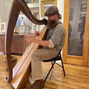 man plays harp