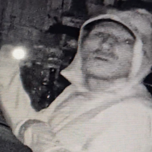 A still from a security video shows the suspect looking around the store with a flashlight. This photo was released to the public in an effort to identify the man. 