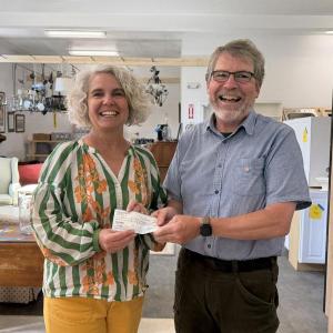 J.P. Fecteau of the West Bay Rotary Satellite Club presents a $1,694 donation to Tia Anderson, Executive Director of Midcoast Habitat for Humanity, inside Midcoast Habitat’s new ReStore location in Rockport. The donation will support a Habitat home in Thomaston.