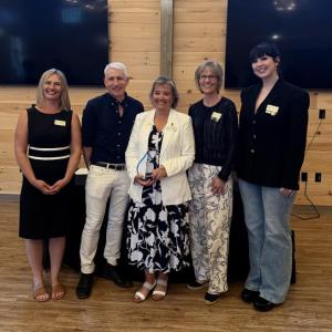 Five adults pose for picture
