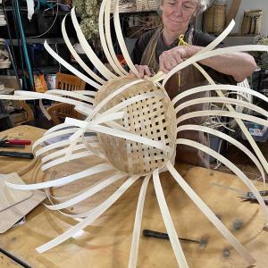 woman weaves basket