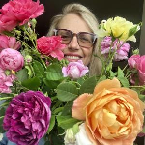 woman poses with roses