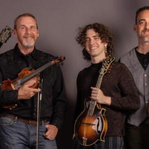four people pose with instruments