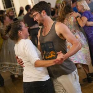 man, woman dance close