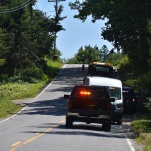 emergency vehicles face crest of hill