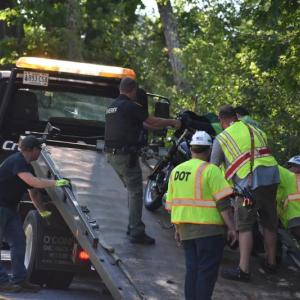 group loads bike onto wrecker